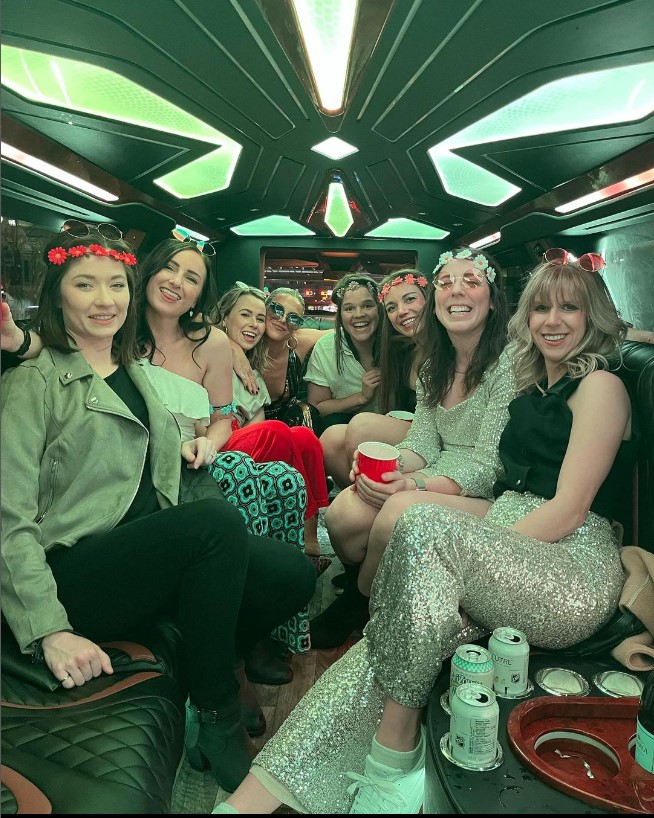 A group of friends sitting together inside a party bus