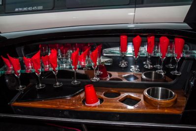 Wet bar inside of limousine, stocked with glasses and napkins