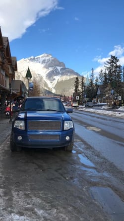 Blue Expedition parked on Main Street in Banff Alberta