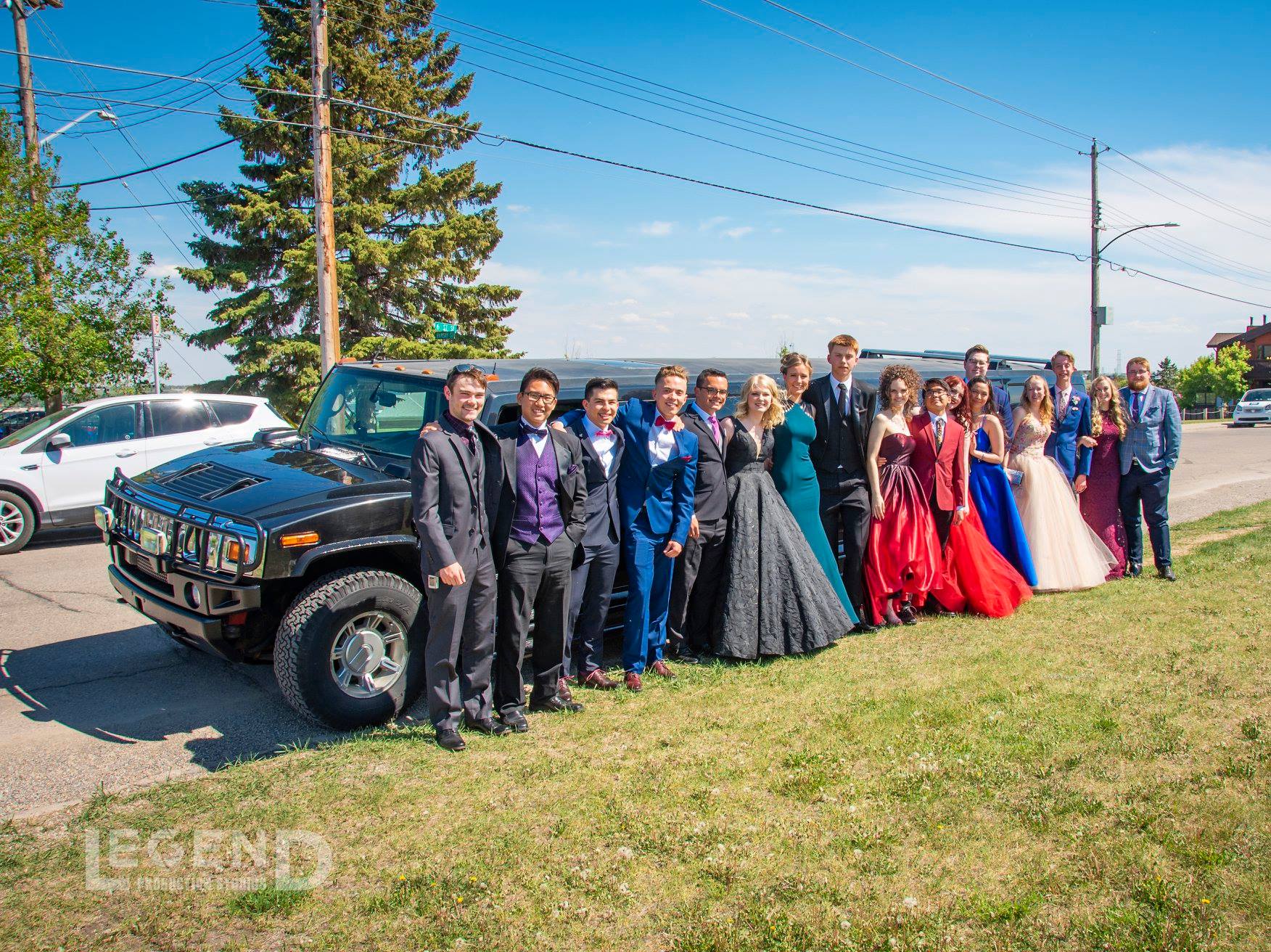 Graduation group photo in front of black Hummer Limousine