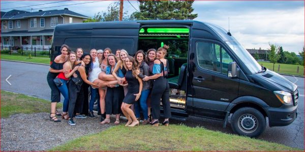 Group of ladies celebrating stagette with photo in front of black Mercedes Mini Party Bus.