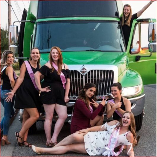 Ladies celebrating stagette in front of green Godzilla Party Bus