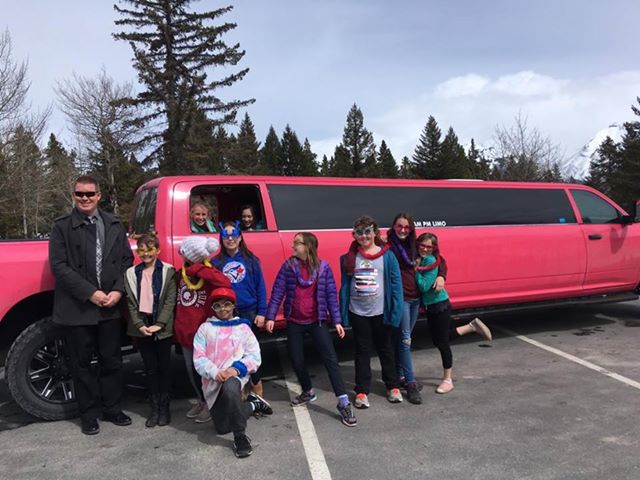 Kids celebrating party with pink dodge ram limo