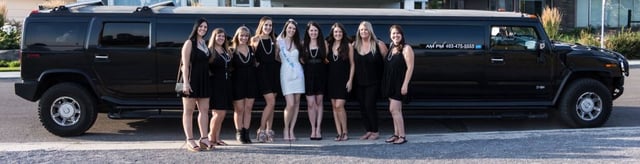 Bridal party photo in front of black Hummer limousine