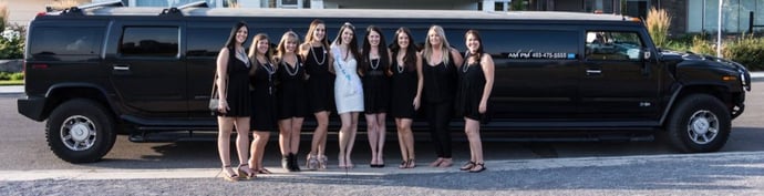 Group of ladies pose in front of black Hummer Limo