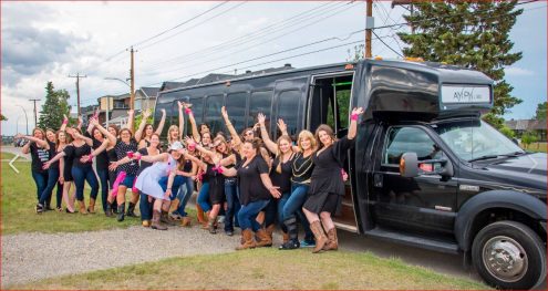group bachelorette celebration photo with black party bus