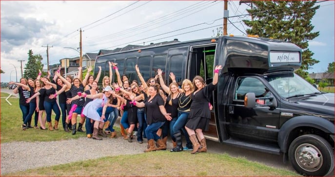 Stagette celebration group photo in front of a black party bus