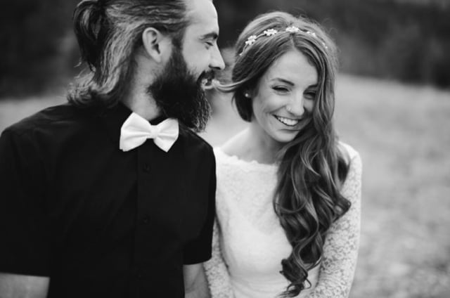 Black and white photo of bride and groom smiling