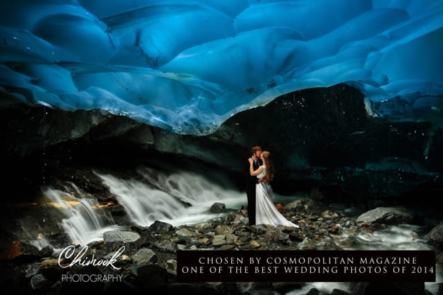 Postcard of bride and groom kissing in front of flowing water