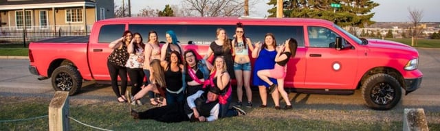 Group of ladies celebrating with Pink Dodge Ram Limo