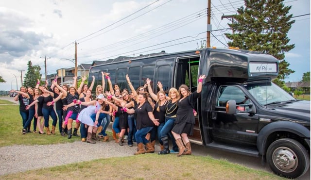 Group of ladies celebrating Stagette with black party bus