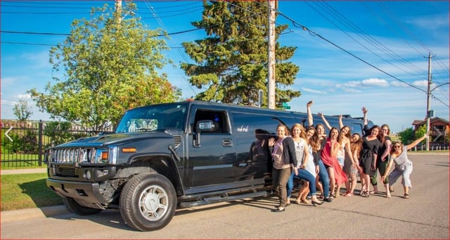 Group of ladies celebrating with black Hummer Limousine