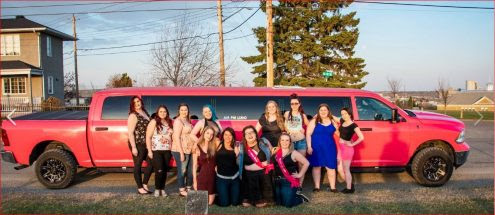 Stagette celebration in front of Pink Dodge Ram Limo