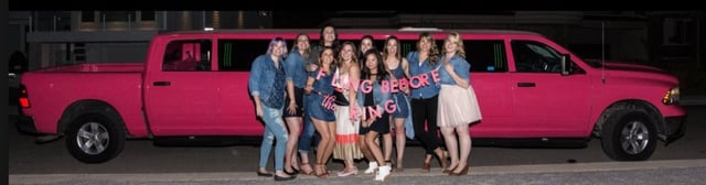 Bachelorette Party photo in front of pink Dodge Ram Limo