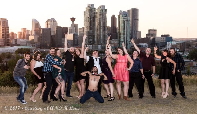 Silly group photo on Crescent Hill with city of Calgary downtown skyline in the background