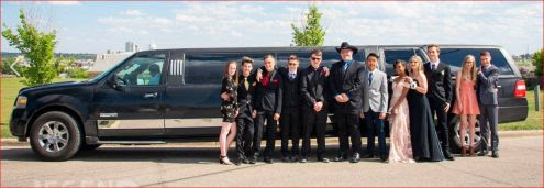 Wedding Party photo in front of black Expedition Limousine