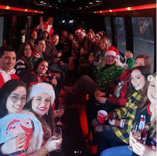 Group Christmas Party celebration inside of a party bus