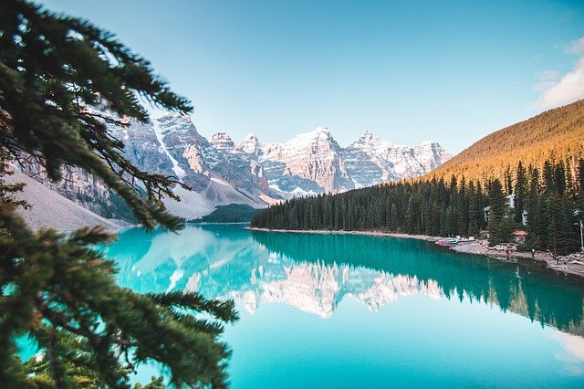 Photo of moraine lake with snowy Rocky Mountains in background