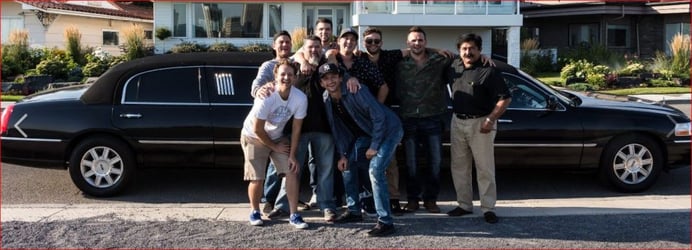 Group photo in front of black Lincoln Stretch limousine