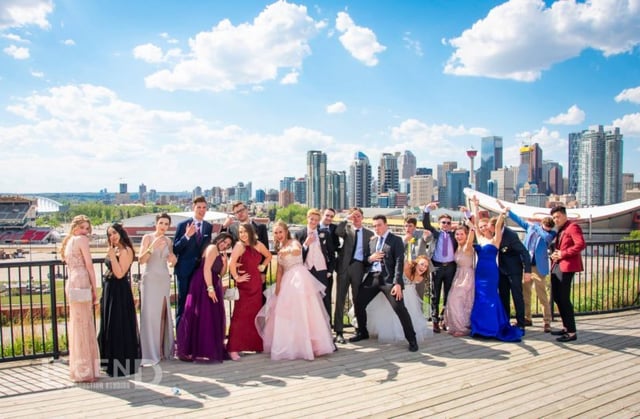 Graduation photo with city of Calgary skyline in background